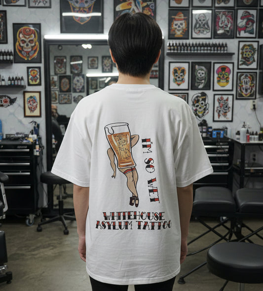 person wearing t shirt in a tattoo studio
